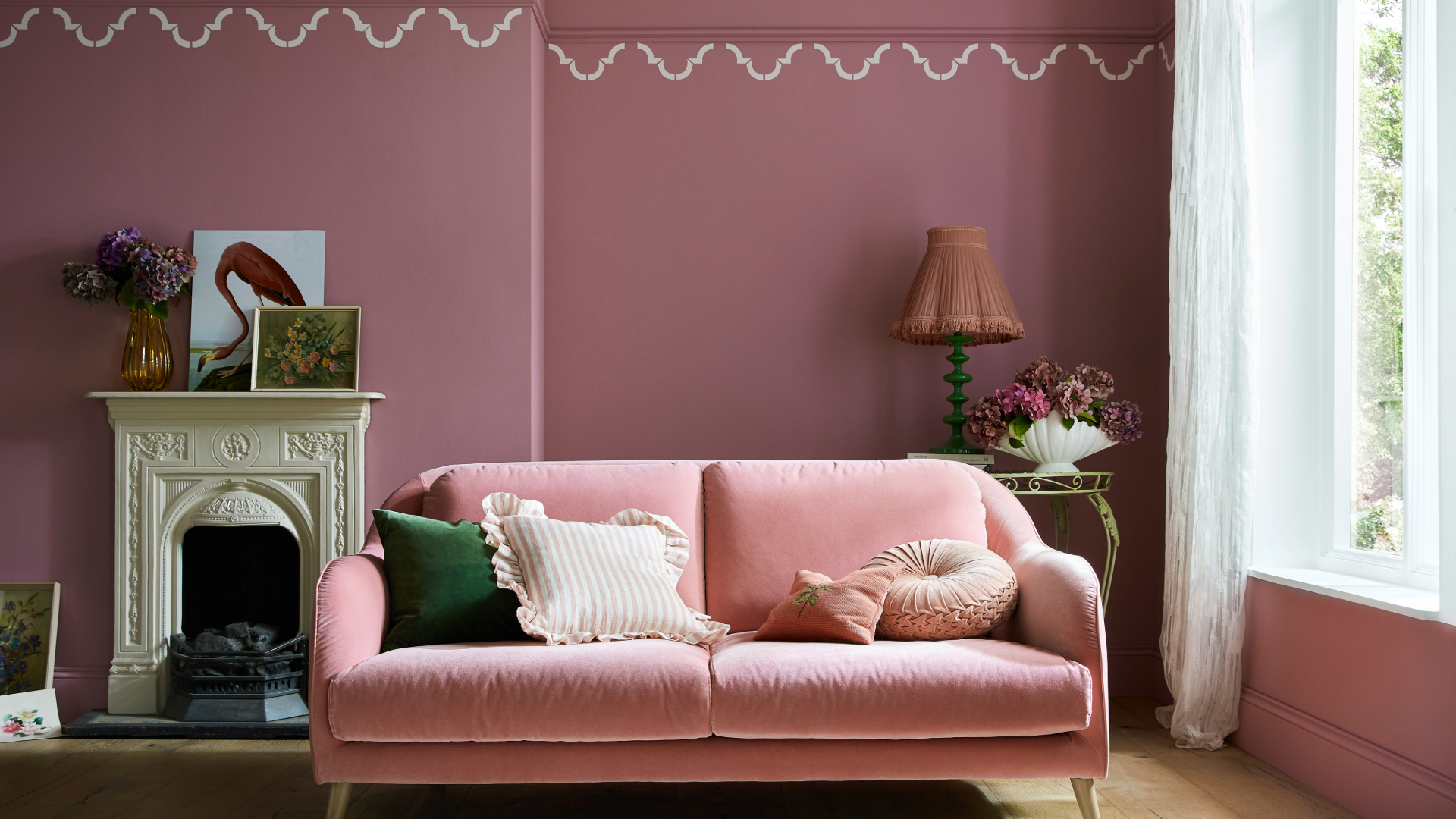 Chintzy soft furnishings in pink living room