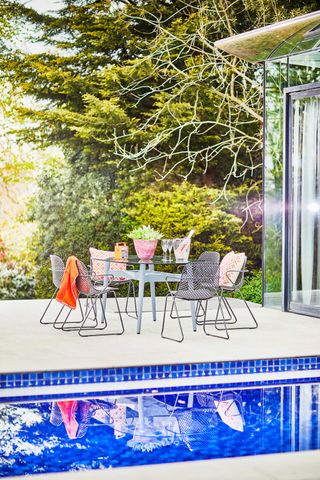 bridgman chairs and tables near pool in summer garden