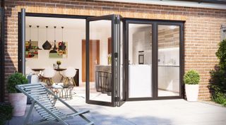 composite bi-fold doors in black attached the contemporary extension by bison