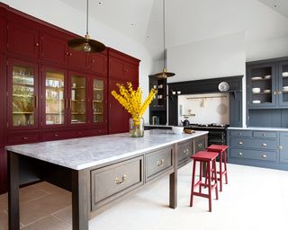 Colorful kitchen with dark red and blue cabinets