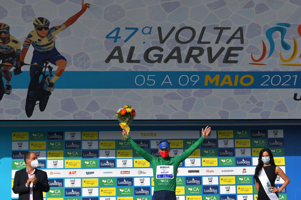 TAVIRA PORTUGAL MAY 07 Sam Bennett of Ireland and Team Deceuninck QuickStep Green Points Jersey celebrates at podium during the 47th Volta Ao Algarve 2021 Stage 3 a 2031km stage from Faro to Tavira Mask Covid Safety Measures Flowers Miss Hostess VoltAlgarve VAlgarve2021 on May 07 2021 in Tavira Portugal Photo by Luc ClaessenGetty Images