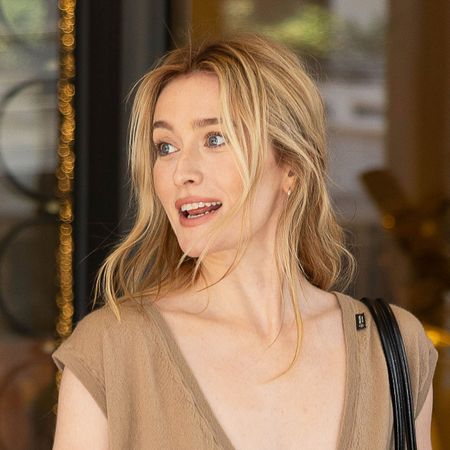 Sarah Pidgeon attending the Prada F/W 26 show during MFW wearing a an oatmeal-colored V-neck tank top and fringed butter yellow skirt with black pumps