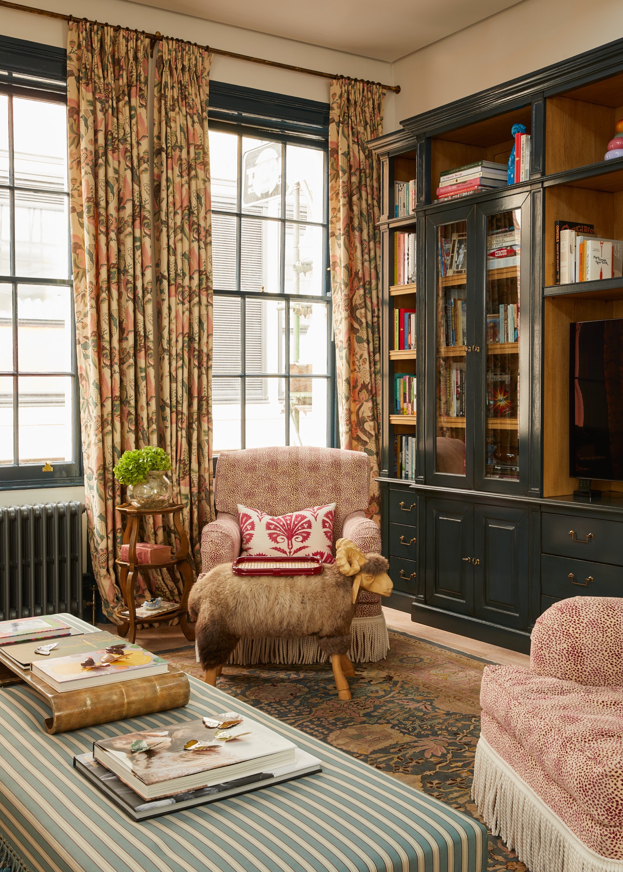 Living room with patterned fringed accent chairs and patterned floral curtains