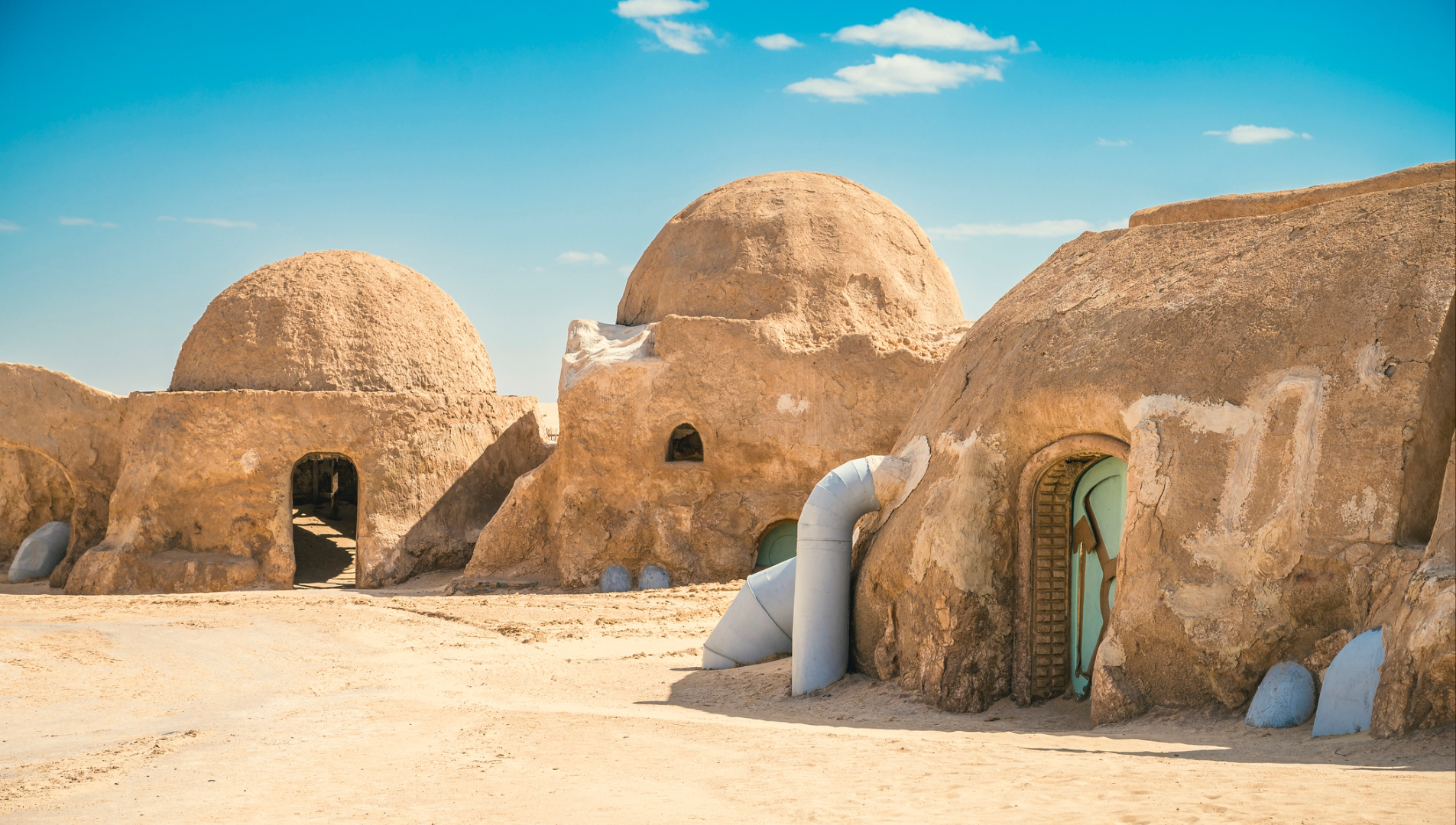 A series of adobe-built dome houses in the desert