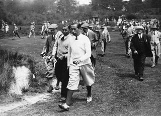 Walter Hagen pictured amongst spectators walking a fairway