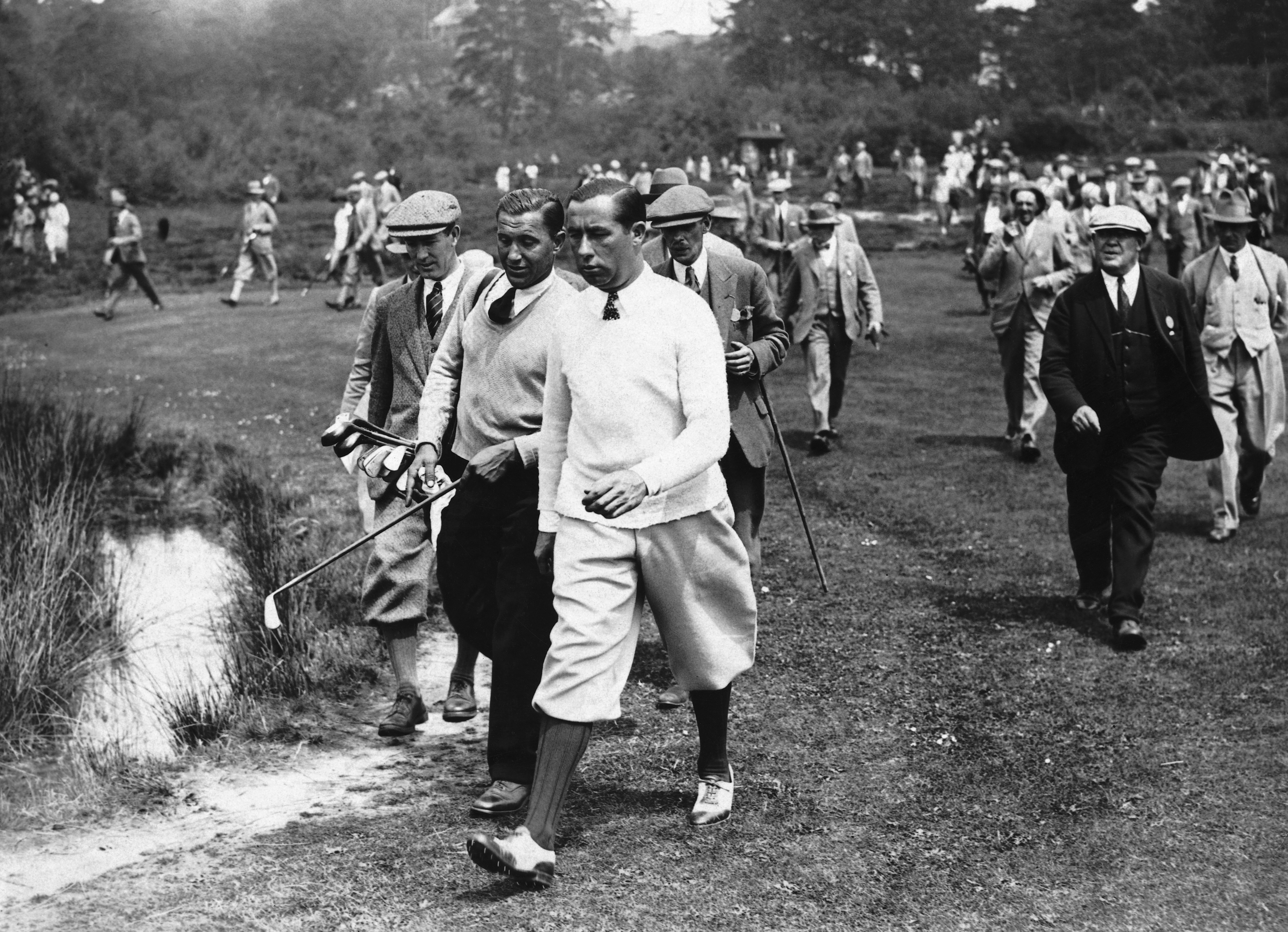 Walter Hagen pictured amongst spectators walking a fairway