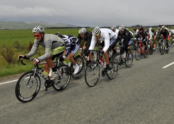 The riders led by PowerNet are strung out as the encounter strong head winds