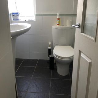 bathroom with black tiles and white sink