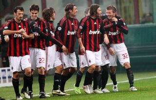 David Beckham celebrates with his AC Milan team-mates after scoring a free-kick against Genoa in 2009.
