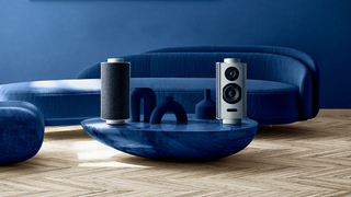 Goldmund Pulp + Hub speaker system in silver on a blue table