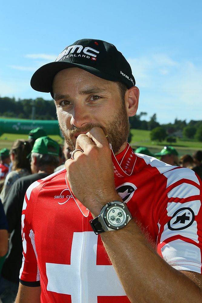 Danilo Wyss bites into his gold medal.