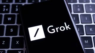 Grok image on a phone screen on top of a keyboard