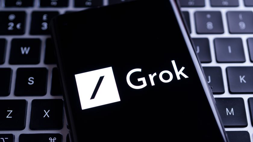 Grok image on a phone screen on top of a keyboard