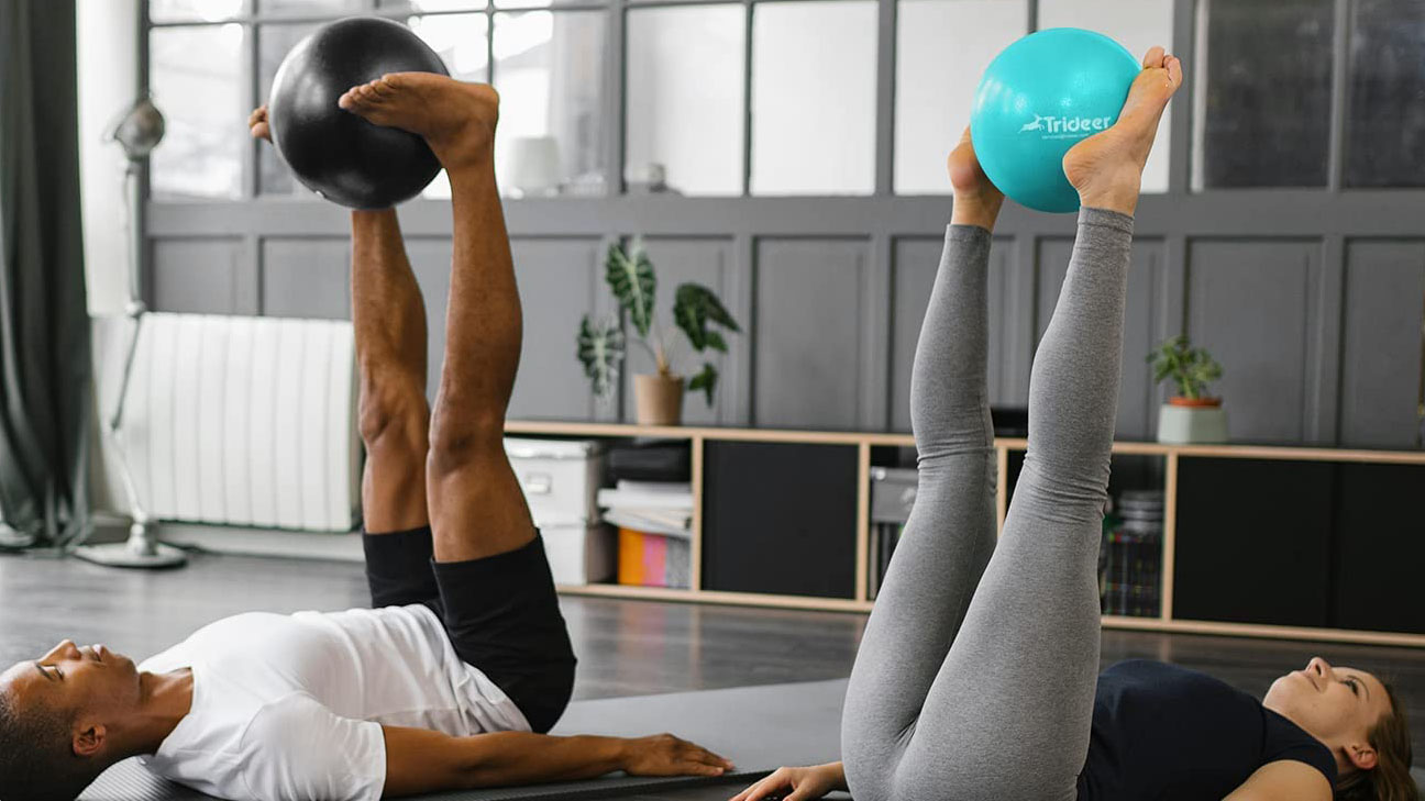 a photo of a woman and a man using an exercise ball