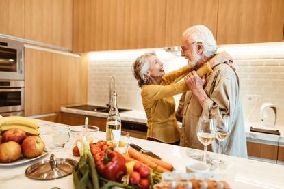 senior couple dancing in the kitchen