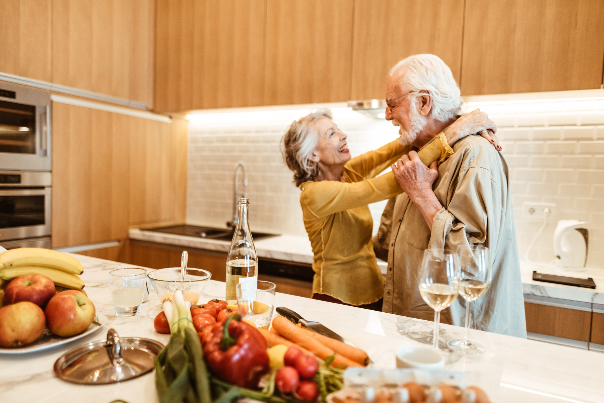 senior couple dancing in the kitchen