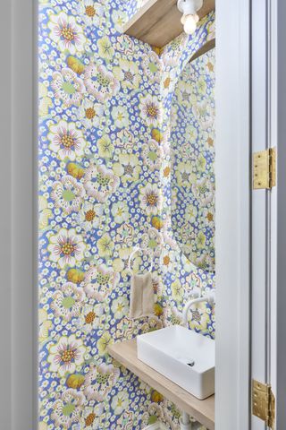 A small bathroom with a wallpaper