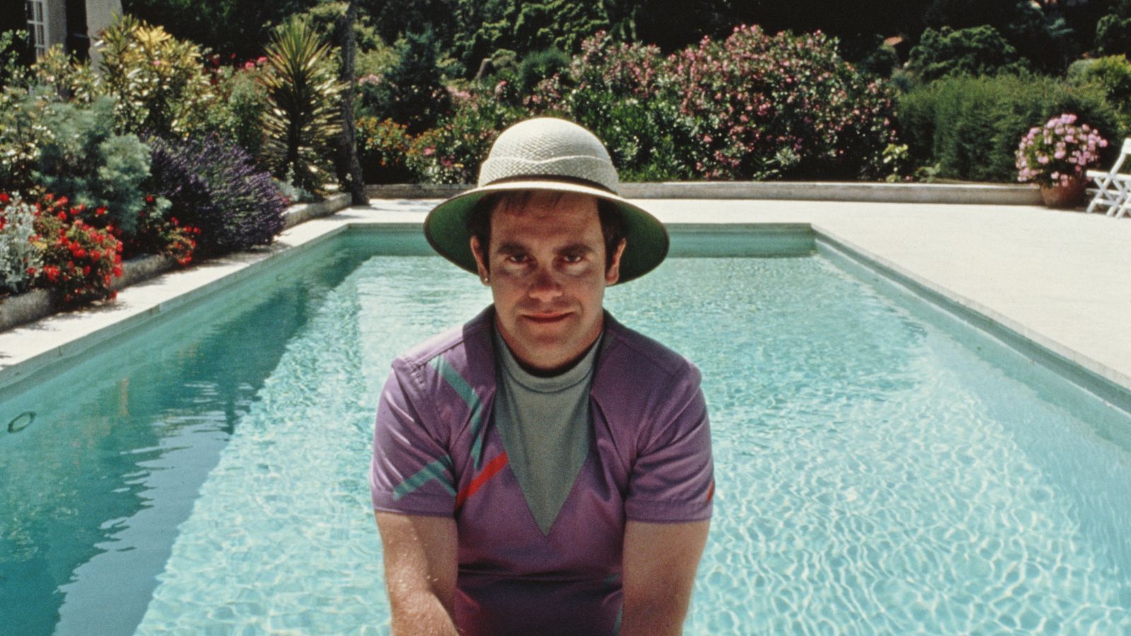 elton john in front of his pool in saint tropez