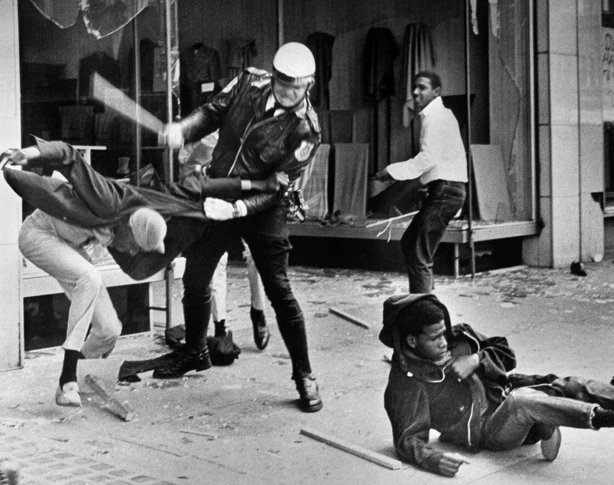 2NGJK2F A police officer uses his nightstick on a youth reportedly involved in the looting that followed the breakup of a march led by Dr. Martin Luther King Jr. March 28, 1968, in Memphis, Tenn. Black leaders accused the police of brutality while police officers said they did what was necessary to restore order. In the wake of the violence, a curfew was imposed and more than 3,800 National Guardsmen were rushed to the city. A week later, King was assassinated at Memphis' Lorraine Motel. (AP Photo/Jack Thornell)