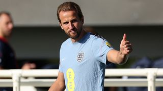 England's striker Harry Kane makes a thumbs-up gesture as he arrives to take part in a training session at St George's Park in Burton-upon-Trent, central England,