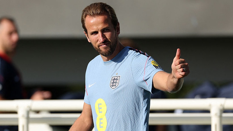 England's striker Harry Kane makes a thumbs-up gesture as he arrives to take part in a training session at St George's Park in Burton-upon-Trent, central England,
