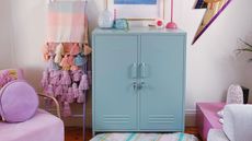 Blue cabinet with colorful blankets