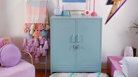 Blue cabinet with colorful blankets