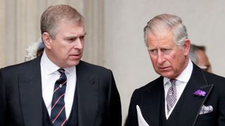 Prince Andrew looks at King Charles, as both royal brothers wear suits in 2012