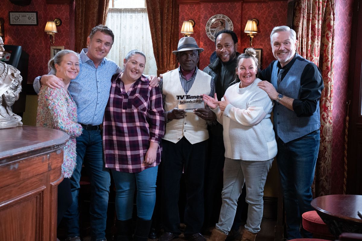 The EastEnders cast in the Vic holding a TV Times award