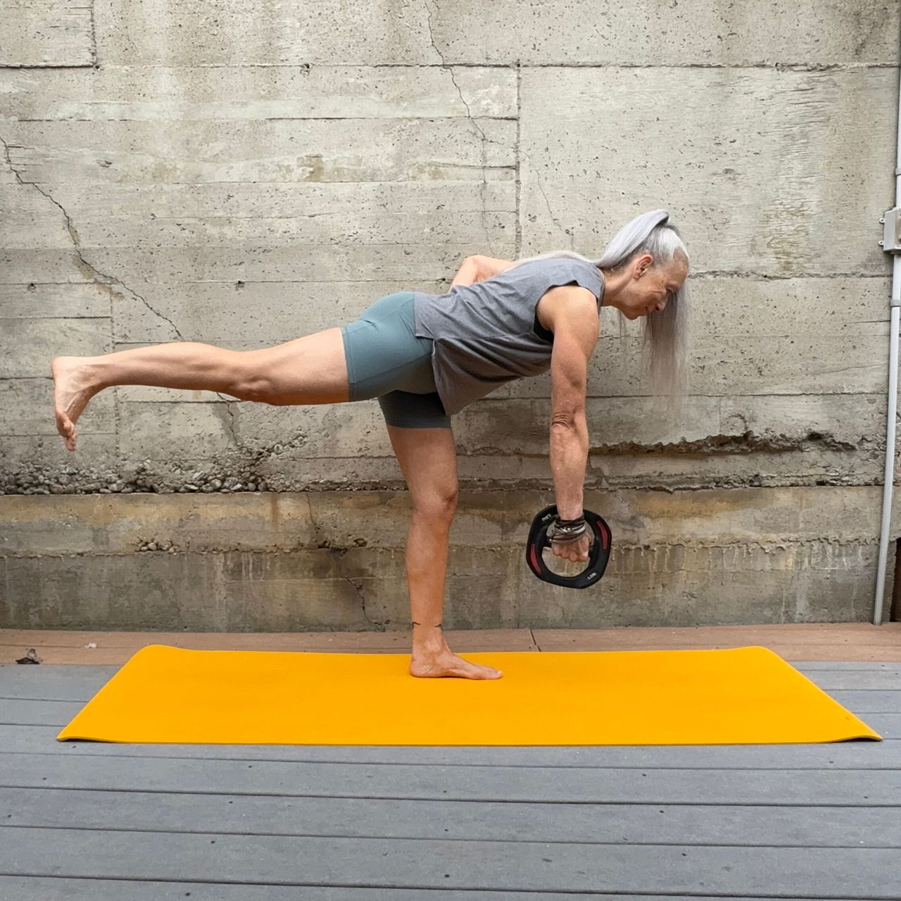 Woman exercising with weight plate