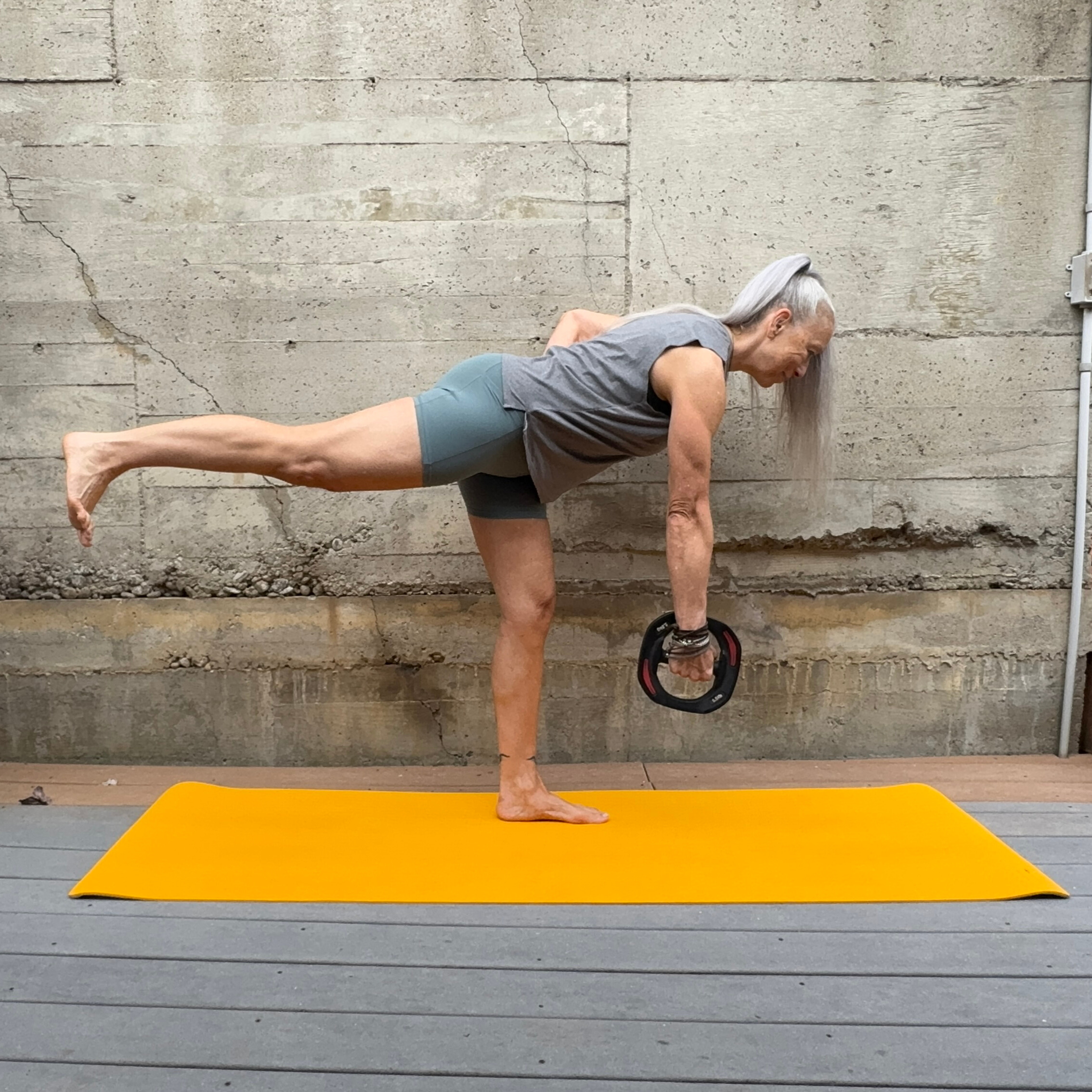 Woman exercising with weight plate