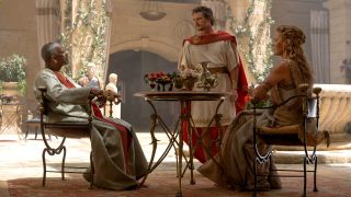 From left to right, Denzel Washington sitting and looking up, Pedro Pascal standing looking at Washington and Connie Nielsen sitting and looking at Washington in Gladiator II.