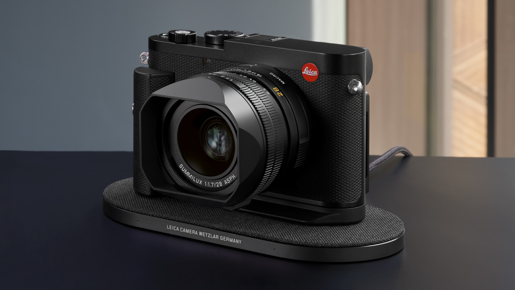 Leica Q3 camera on a wireless charging dock