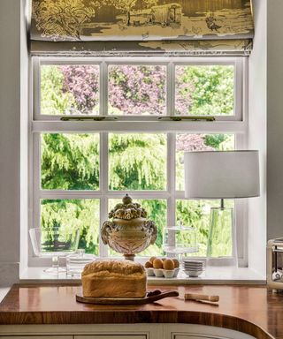 wooden kitchen countertop with baked bread and white lamp