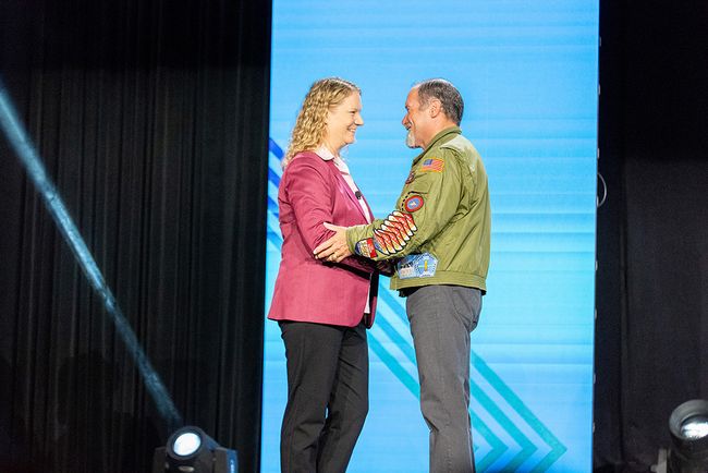 NCTC COO and CFO Lisa Hood shakes hands with retired U.S. Navy Rear Adm. Mike Manzanir after his Independent Show keynote speech.