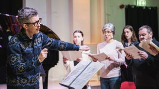 Gareth Malone in a blue patterned jacket rehearses a group of singers in Gareth Malone's Easter Passion.