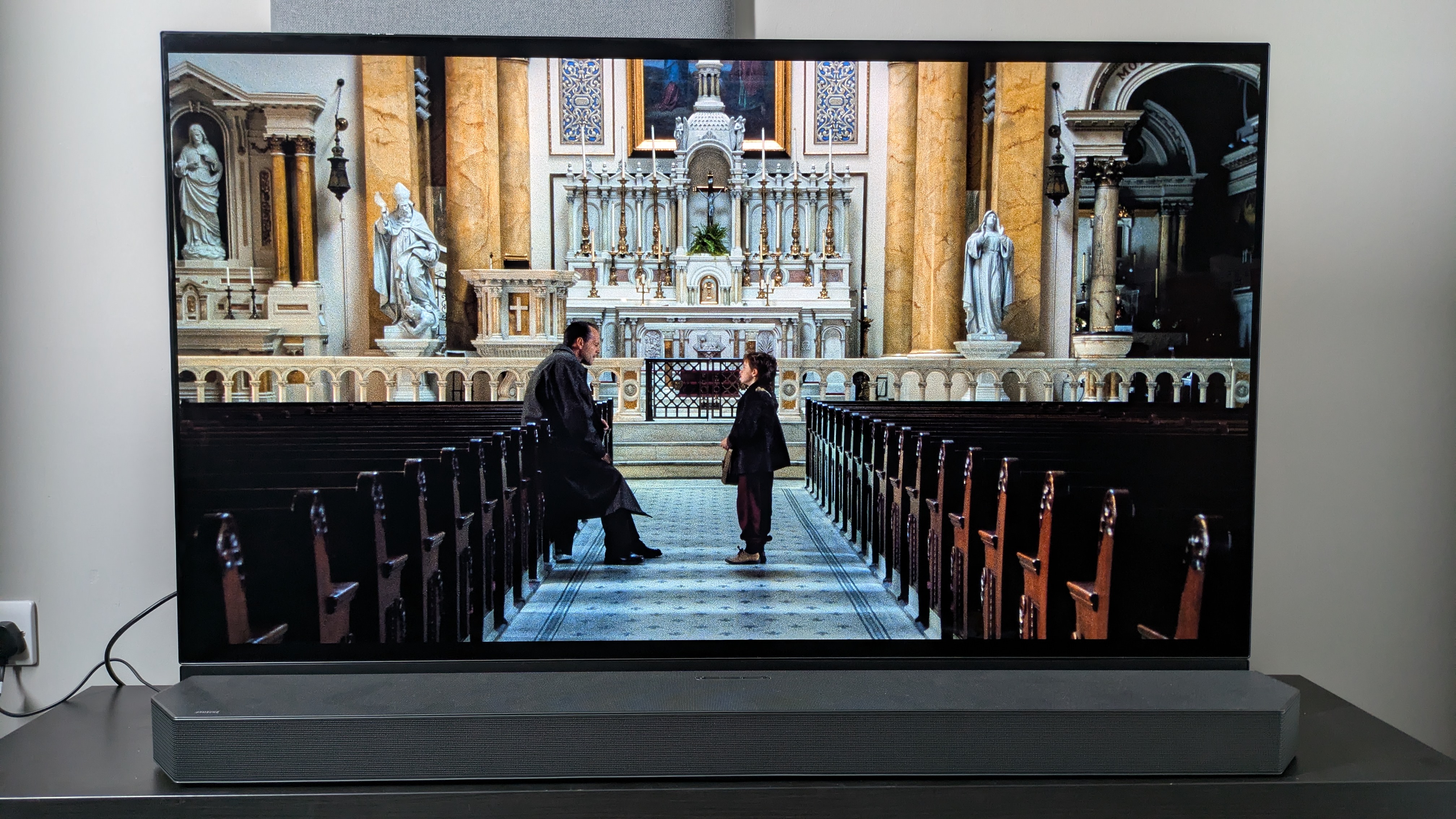 The Sixth Sense Church scene on the Panasonic MZ1500 OLED TV with the Samsung HW-Q990C soundbar in front of the TV