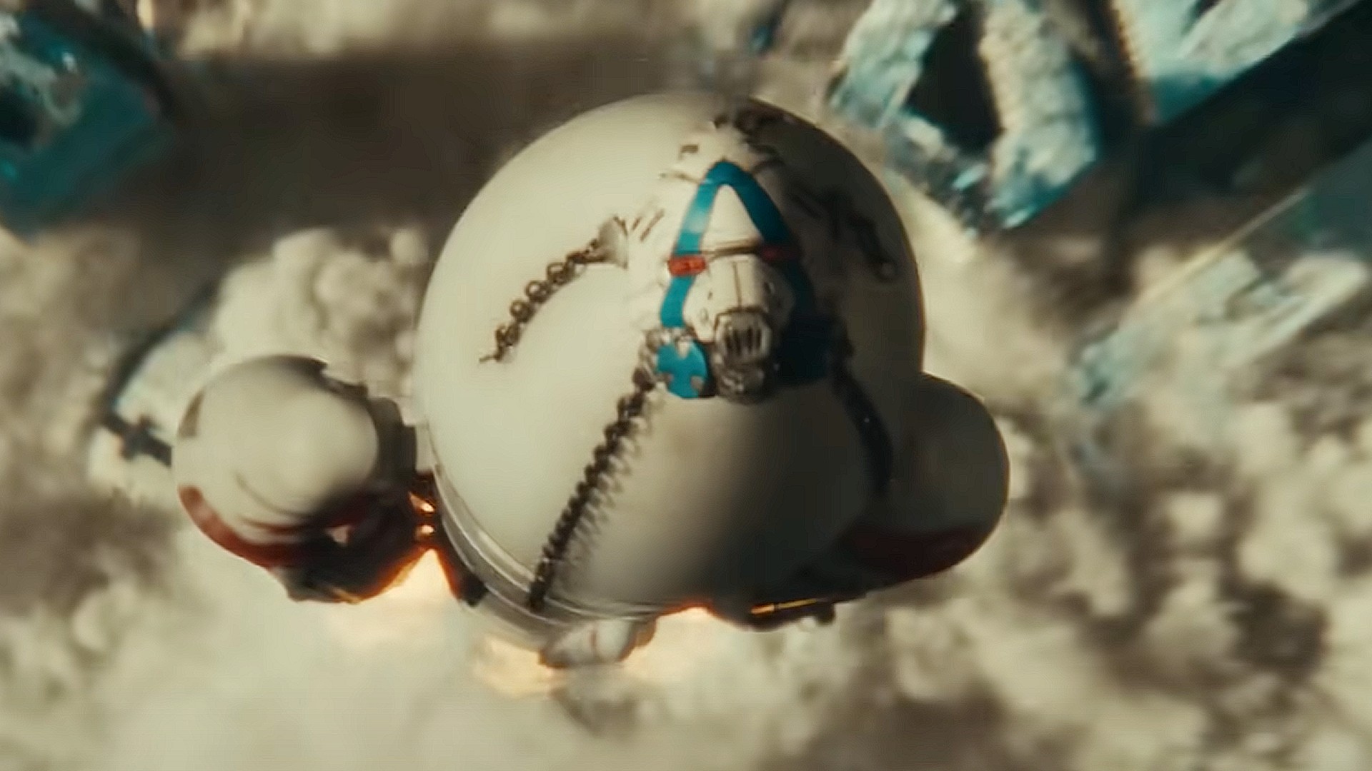 a large rocket looms in the distance behind a bus with the words &quot;Quit Earth&quot; on it