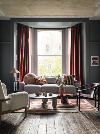 Dark grey living room with rust red accessories
