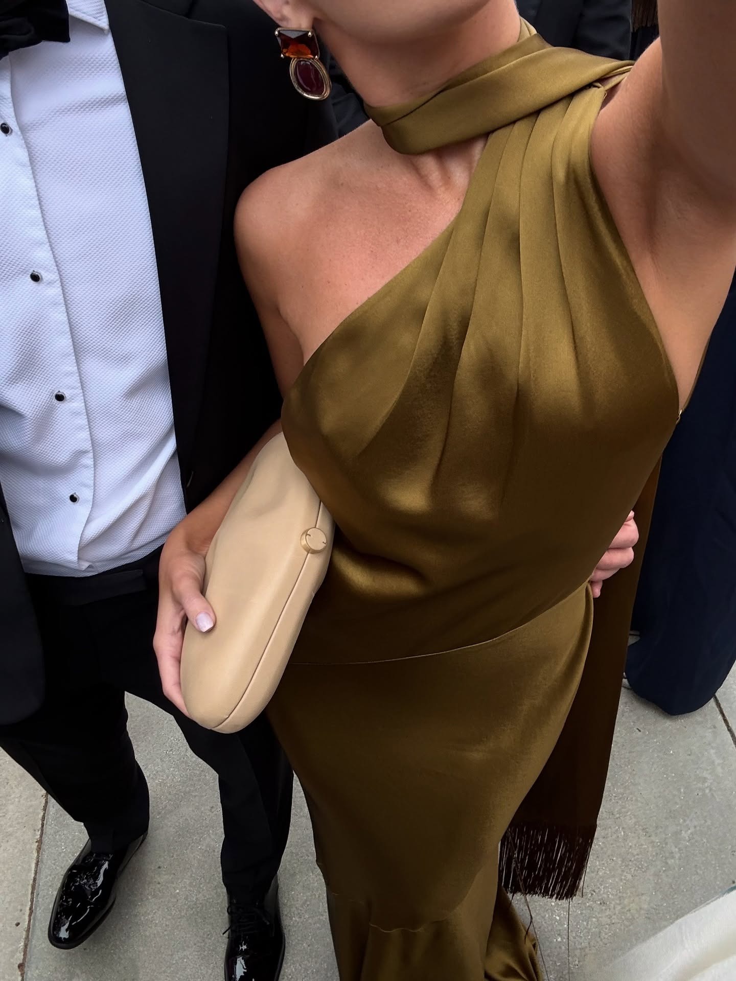 Image of influencer @emmaleger wearing a olive satin scarf dress.