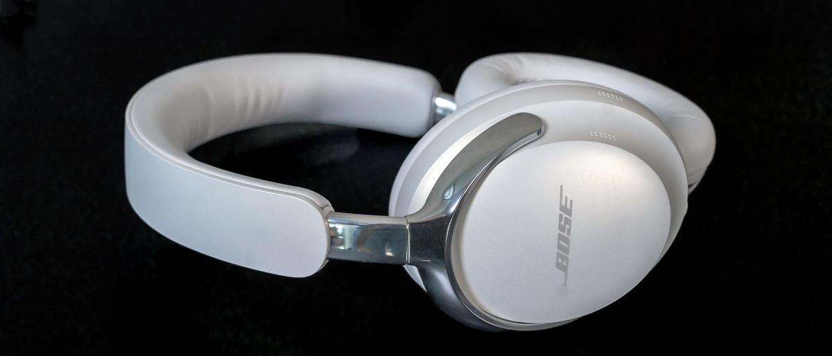 Side view of Bose QuietComfort Ultra headphones laying flat.