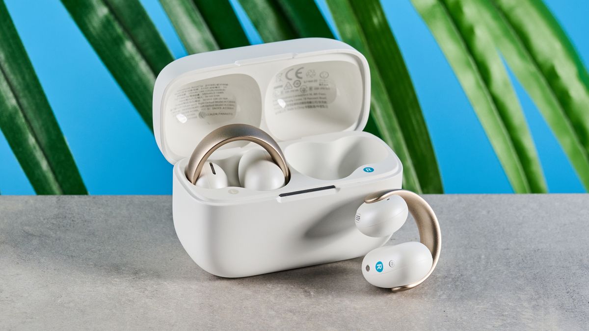 Soundcore AeroClip open-ear earbuds in champagne mist against a blue backdrop 