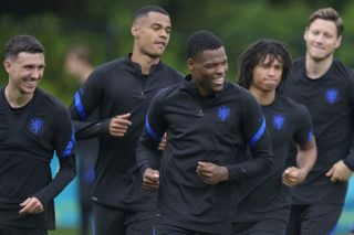 Netherlands players, from left, Steven Berghuis, Cody Gakpo, Denzel Dumfries, Nathan Ake, and Wout Weghorst, warm up during training on Sunday