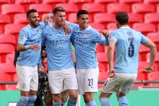 Aymeric Laporte (second left) celebrates with team-mates after scoring for Manchester Ciy against Tottenham in the 2021 League Cup final.