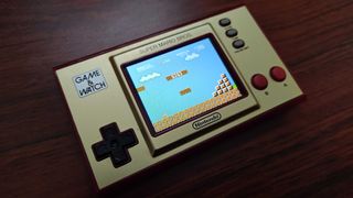 Nintendo Game & Watch Super Mario Bros. edition on a wooden table