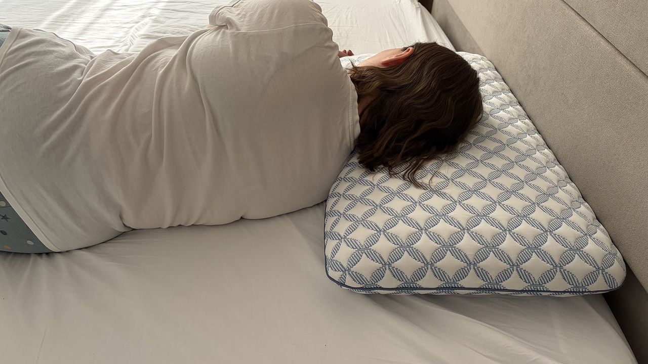Tester Ruth Jones lies on the Helix Cooling Memory Foam Pillow in her bedroom, in a side sleeping position