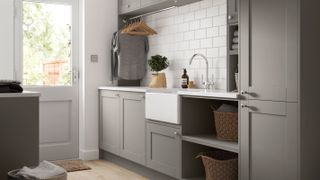 grey painted laundry room with butler sink