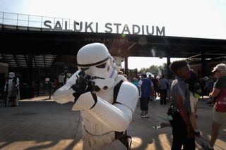 A person dressed as a Stormtrooper from "Star Wars" poses in front of Saluki Stadium as people file in to view the solar eclipse.