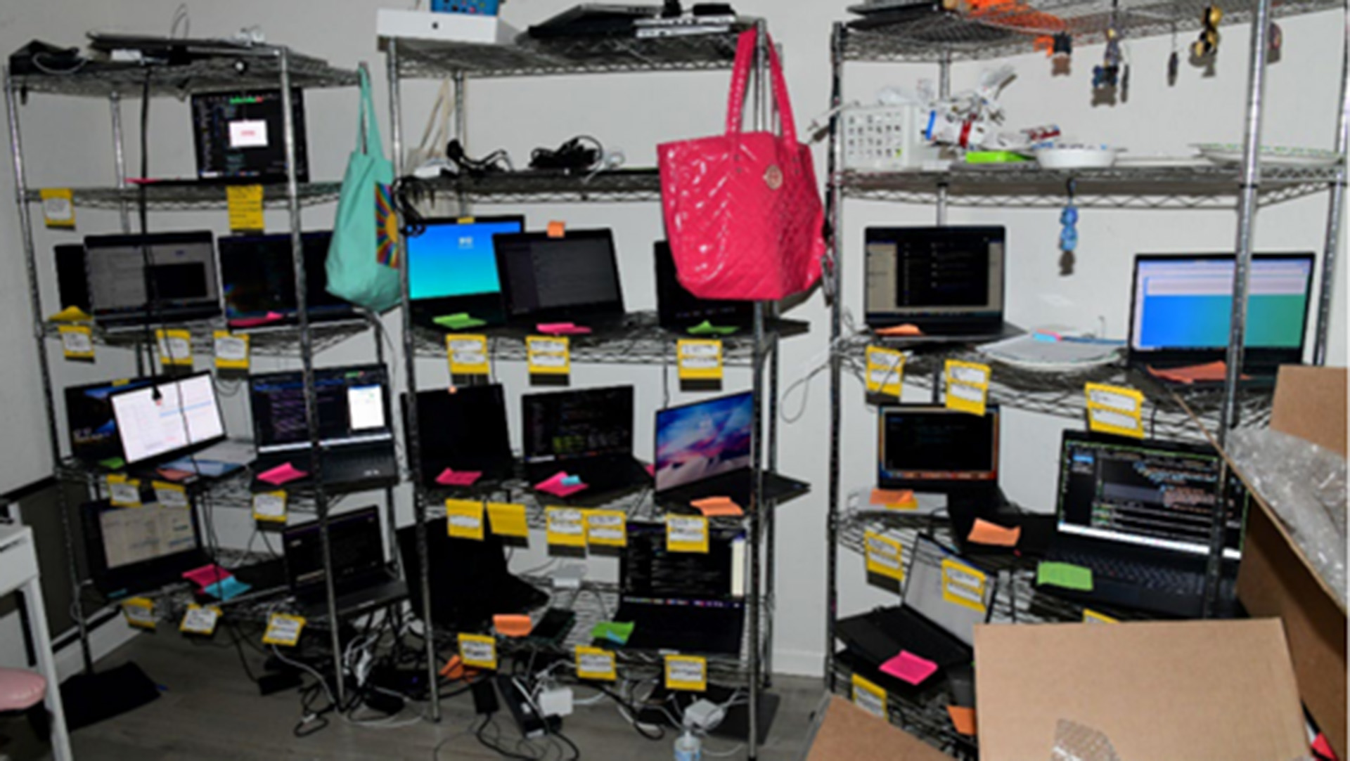 An image of a laptop farm used to run an IT remote worker scam in the US.