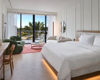 bed with white bed linen and comfy tufted seating with paneling